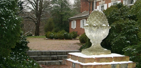 Colonial Revival style garden pineapple gate ornament at the entry of the Corbit-Sharp House